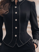 Black tailored blazer with ornate embroidery by Lumina Wear, featuring detailed embroidery on the front, worn by Elena.