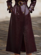 Burgundy Nell Lumina trench coat for women, slim fit, with classic collar and button details, displayed on a hanger.