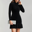 Black velvet mini dress with high neckline by Lumina Vancouver, shown on a model, featuring a sleek, fitted silhouette.