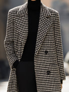 Black houndstooth wool long coat by Lumina Vancouver, featuring a tailored fit and classic design, worn by Elena.