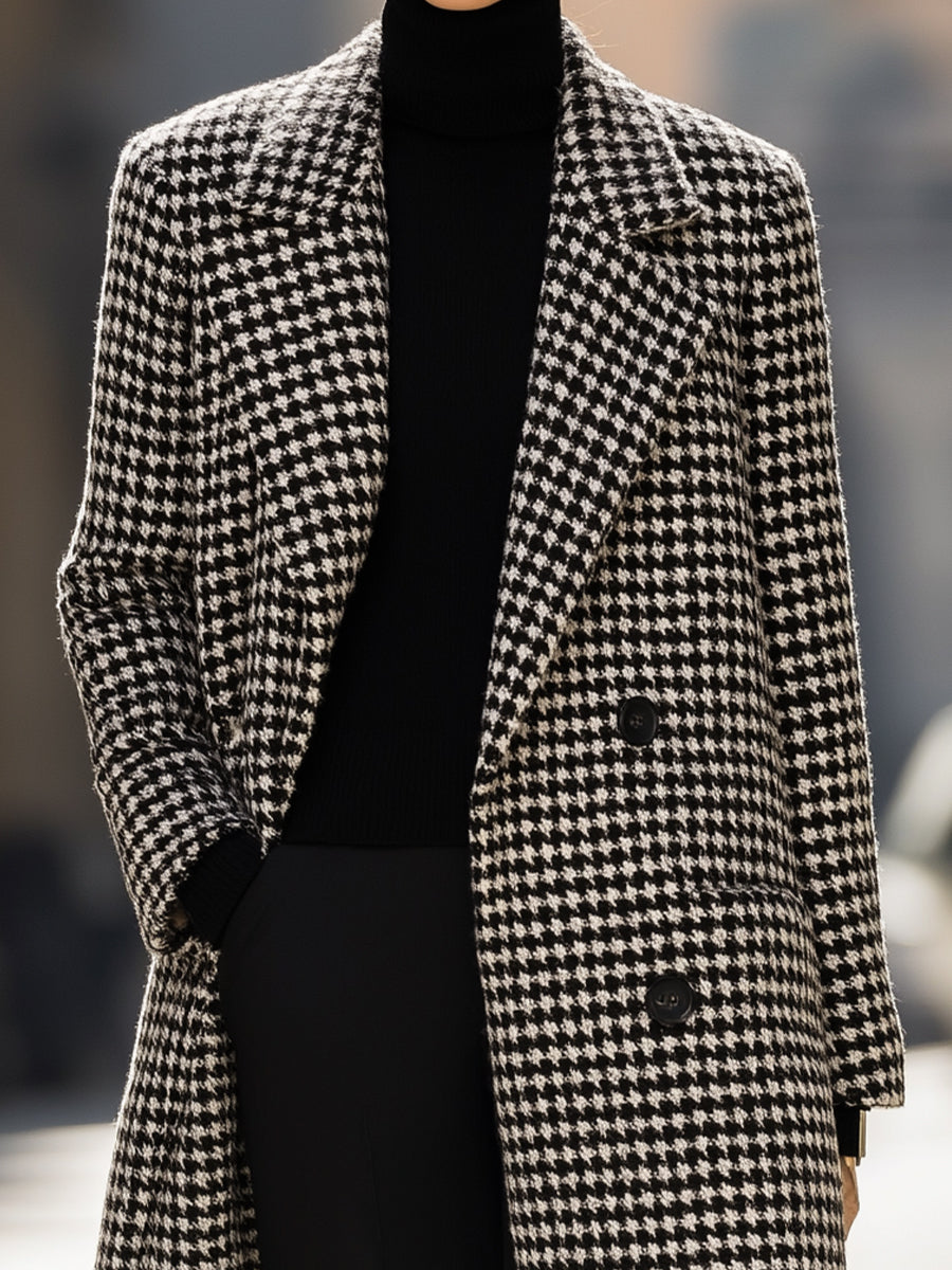 Black houndstooth wool long coat by Lumina Vancouver, featuring a tailored fit and classic design, worn by Elena.