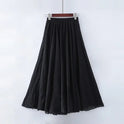Beige Elianne maxi skirt by Lumina Wear featuring a high waist and elegant flowy design, shown on a model.