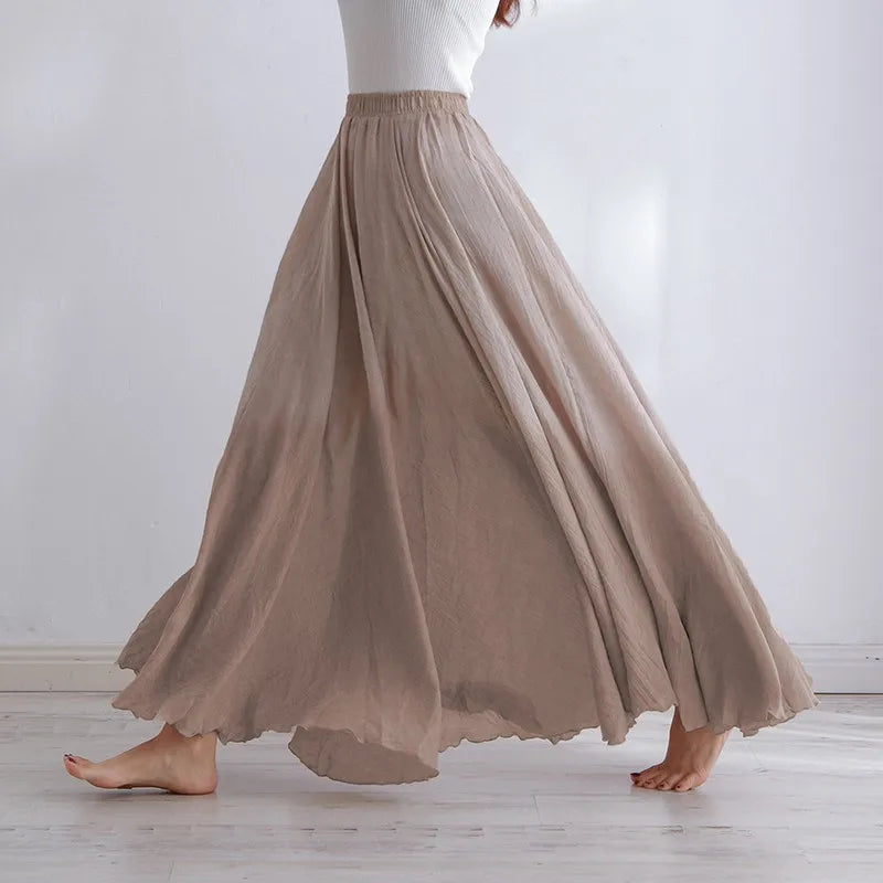 Elegant beige maxi skirt with high waist from Lumina Wear, featuring flowing fabric and a stylish silhouette.