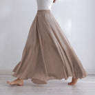 Elegant beige maxi skirt with high waist from Lumina Wear, featuring flowing fabric and a stylish silhouette.