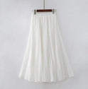 Elegant beige maxi skirt with high waist by Lumina Wear, showcased on a mannequin, emphasizing flowy fabric and stylish design.