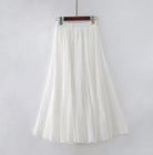 Elegant beige maxi skirt with high waist from Lumina Wear, displayed on a mannequin, showcasing flowing fabric and stylish fit.