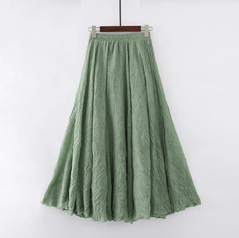 Elegant beige maxi skirt with high waist by Lumina Wear, showcased flowing in a natural pose.