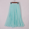Beige Elianne Lumina Wear elegant high-waist maxi skirt displayed flat, showcasing its flowy fabric and sophisticated design.