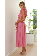 Pink Severine elegant summer wedding guest dress by Lumina Vancouver, featuring flowing fabric and stylish design.