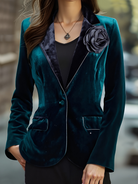 Emerald velvet blazer by Lumina Vancouver with satin lapels and rose embroidery, tailored fit, stylish formal or evening wear piece.
