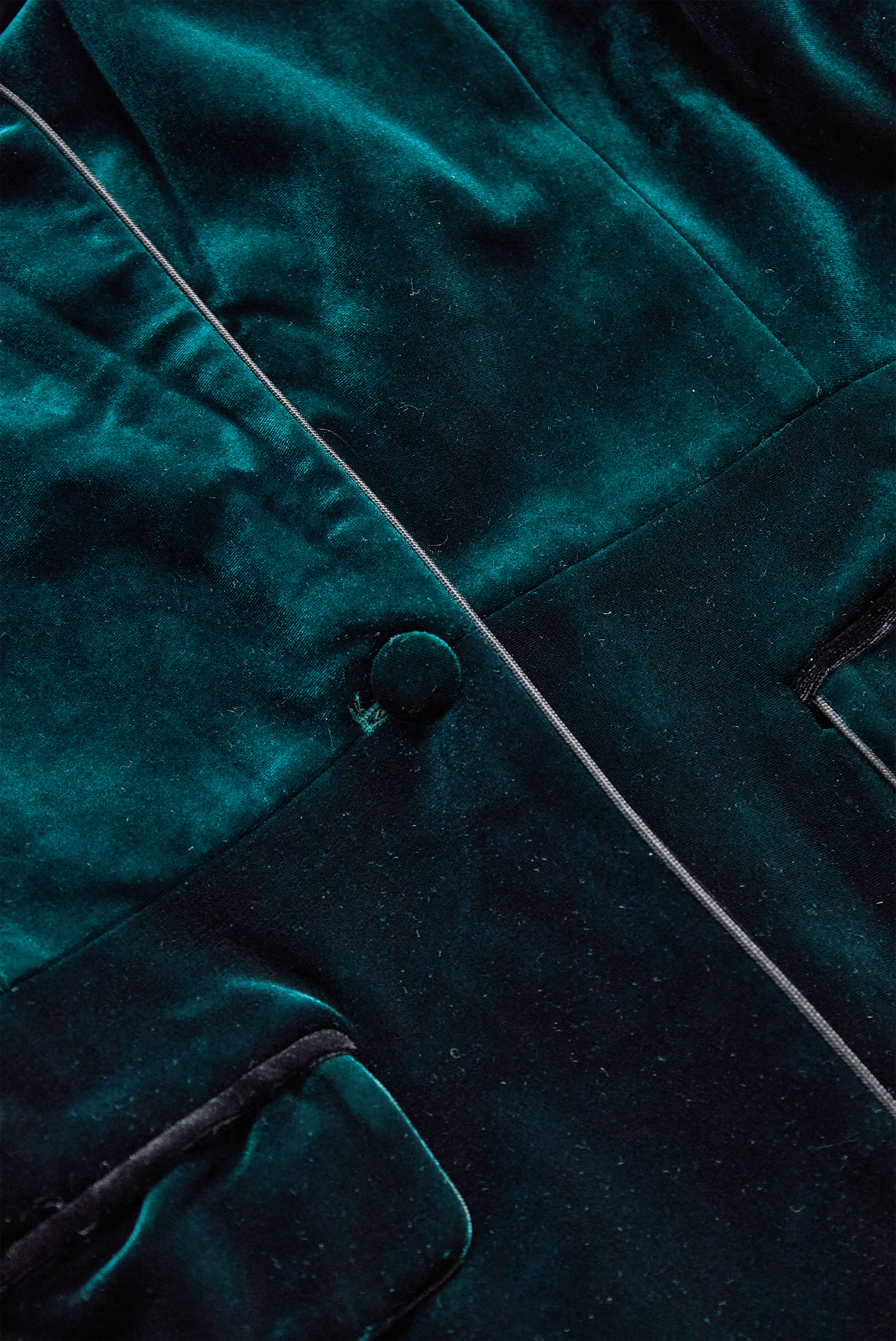 Emerald velvet blazer with satin lapels and rose embroidery by Lumina Vancouver, showcasing tailored fit and intricate floral details.