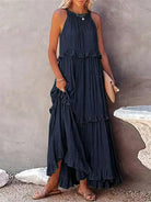 Laila halter ruffle maxi dress in apricot by Lumina Vancouver, flowing dress with ruffle details, showcased on a model.