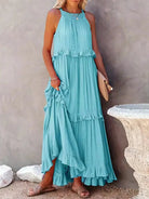 Laila halter ruffle maxi dress in apricot from Lumina Vancouver, flowing fabric with ruffle details, perfect for summer occasions.