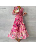 Lumina Wear Emily elegant floral evening dress for wedding guests, featuring a stylish floral pattern and flowing fabric.