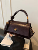 Black Lumina Wear Emma chic versatile handbag with crossbody strap, featuring sleek design and spacious interior.