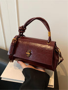Black Lumina Wear Emma versatile satchel handbag with crossbody strap, stylish and practical for everyday use.