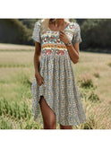 Multicolor Esmera Bohemian Breeze Dress by Lumina Wear featuring flowing fabric and relaxed fit, displayed on a hanger.