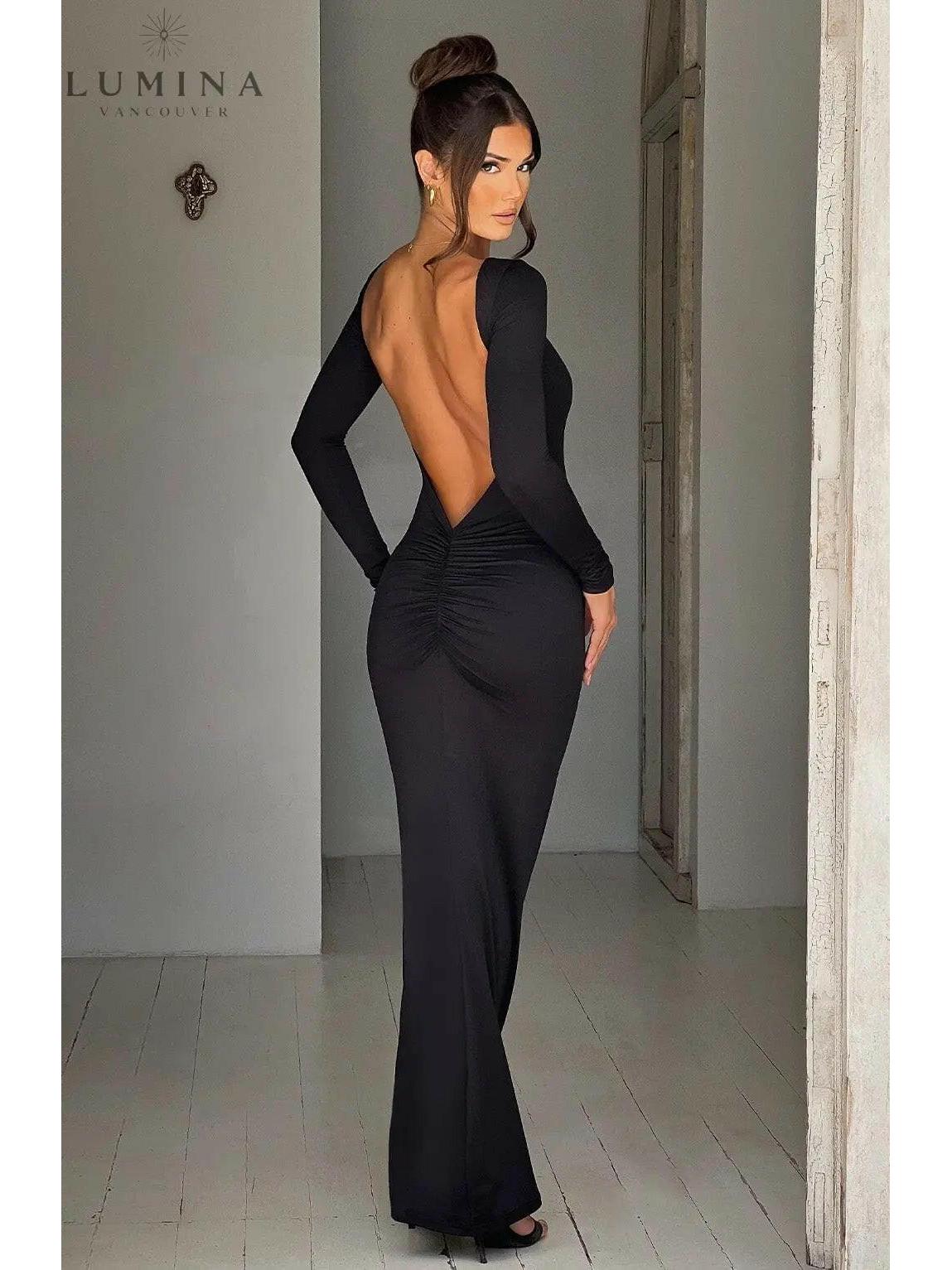 Evanna boat-neck backless maxi dress by Lumina Vancouver featuring a flowing silhouette and elegant design, shown on a model.