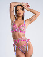 Pink embroidery lingerie set with floral details, including bra, panties, and garter belt from Lumina Vancouver.
