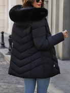 Black Florence Lumina Wear quilted puffer coat with faux-fur hood, stylish and warm winter outerwear for women.
