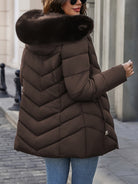 Black Lumina Wear Florence quilted puffer coat with faux-fur hood, stylish winter outerwear for cold weather.