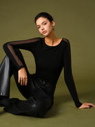 Black Florence mesh sleeve t-shirt from Lumina Wear with a relaxed fit and stylish design, shown on a model.