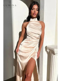 Burgundy Florencia halterneck sleeveless slit maxi dress by Lumina Wear, perfect for wedding guests, shown on a model.
