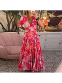 Lumina Wear Floriana vibrant floral dress in red, flowing fabric, perfect for spring and summer occasions.