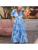 Red Floriana floral dress by Lumina Wear featuring vibrant flower patterns and a stylish fit, perfect for spring and summer wear.