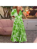 Lumina Wear Floriana vibrant floral dress in red, showcasing its colorful pattern and flowing fabric design.