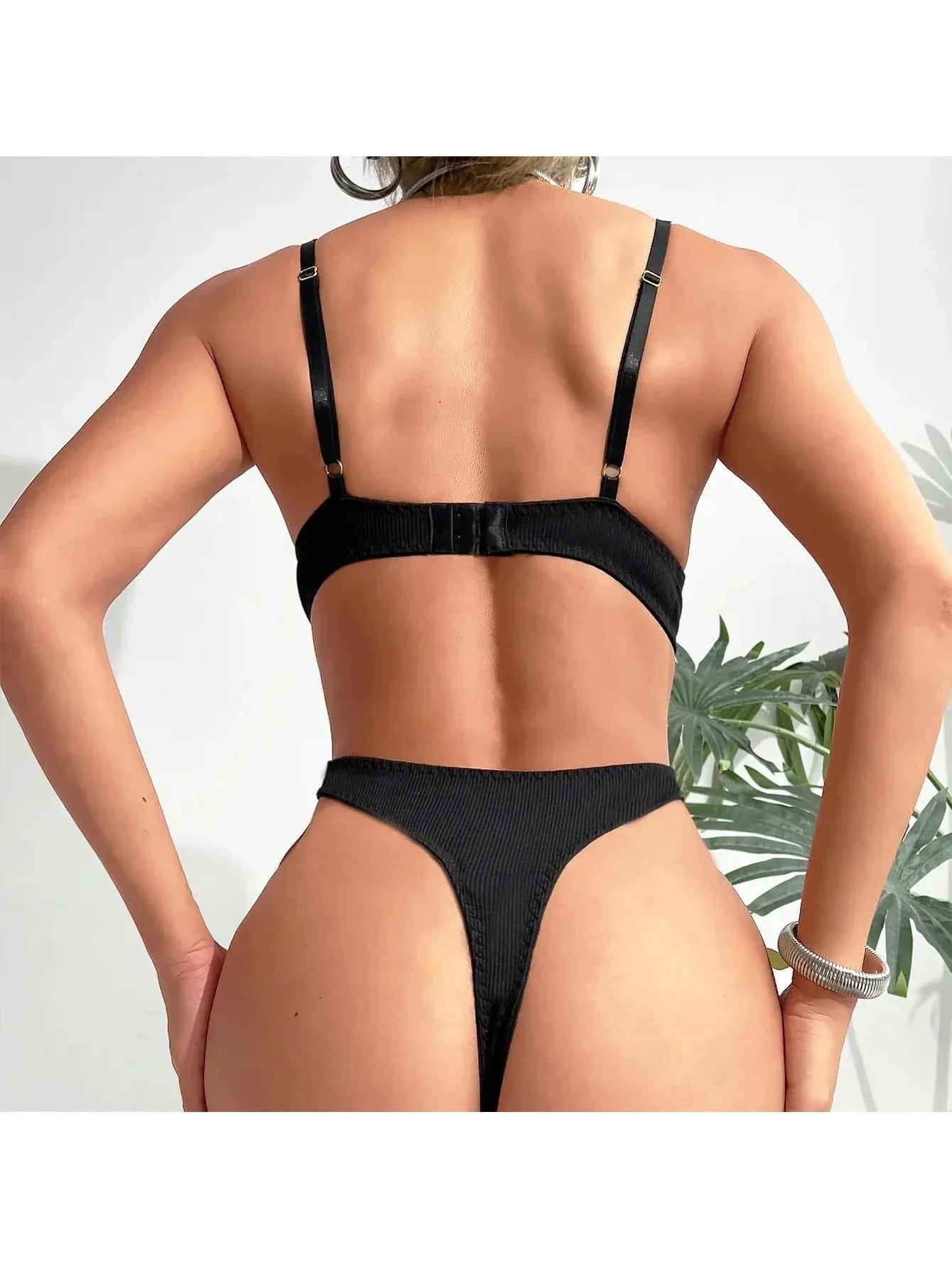 Lumina Vancouver Gabriella's bodysuit in black, fitted with long sleeves and scoop neckline, displayed on a white background.