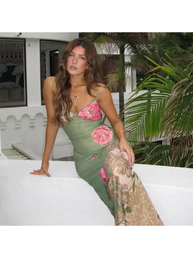 Green Gaia flower dress by Lumina Vancouver, perfect for holiday vibes, featuring a floral design and lightweight fabric.