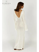 Elegant white Giana dress by Lumina Vancouver, perfect for holiday vibes, shown on a model with stylish details.