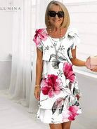 White Giselle floral dress by Lumina Vancouver, featuring a flowy fabric and elegant design, perfect for spring and summer wear.
