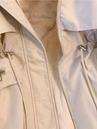Beige Hailey Lumina Wear utility parka jacket with cozy faux-fur trim, featuring a practical design and warm winter style.