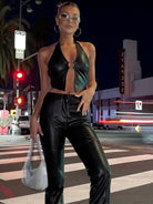 Black halter faux leather backless corset tank top with metal ring hollow-out design, from Lumina Vancouver.
