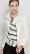 Black lightweight puffer jacket with stand collar by Lumina Wear, shown in XS size, designed for warmth and style.