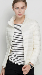 Harriet Lumina Wear lightweight black puffer jacket with stand collar, displayed in XS size, perfect for cold weather.