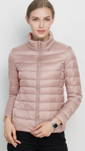 Harriet lightweight black puffer jacket with stand collar by Lumina Wear, shown in XS size on a model.