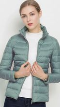 Black lightweight puffer jacket with stand collar from Lumina Wear, featuring a sleek design perfect for casual wear.