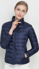 Harriet black lightweight puffer jacket with stand collar by Lumina Wear, shown in matcha color, front view.