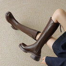 Elegant black knee-high boots for women by Lumina Wear with orthopedic support and brown fur accents.