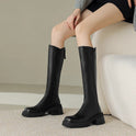 Elegant black knee-high boots with orthopedic support from Lumina Wear, featuring brown fur accents and a stylish design.