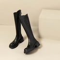 Elegant black knee-high boots by Lumina Wear featuring orthopedic support and brown fur accents for women.