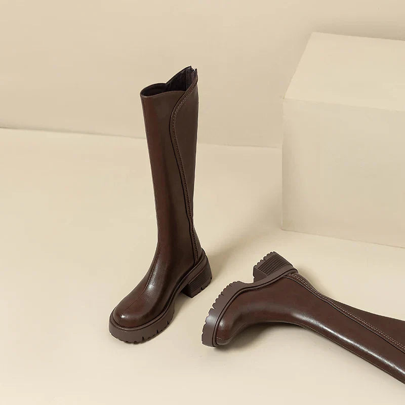 Elegant black knee-high women's boots by Lumina Wear with orthopedic support and brown fur trim.