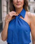 Lumina Wear Luna sleeveless halter blouse with neck tie, white fabric, and stylish design, shown on a hanger.