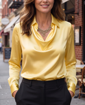 White Delphine blouse from Lumina Wear featuring elegant draped fabric and a stylish, flowy design.