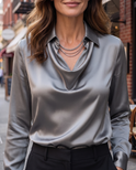 White draped blouse from Lumina Wear, Delphine style, featuring elegant fabric and a relaxed fit on a model.