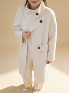 Lumina Wear structured asymmetrical button coat in Elena Frost style, shown in a clean silhouette