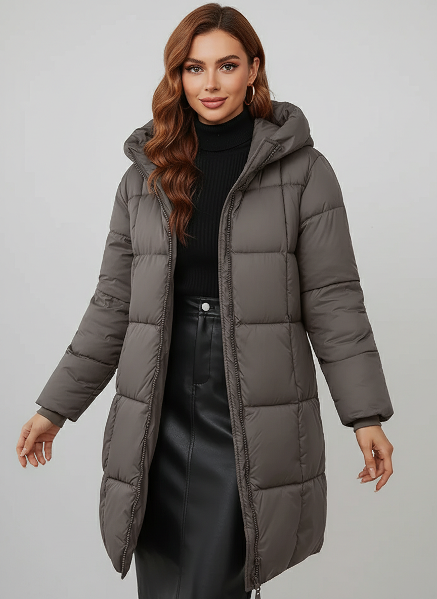 Redish-brown Holly Lumina longline hooded puffer coat with minimalist design, featuring a cozy, insulated look and a stylish silhouette.